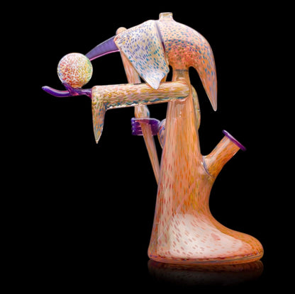 Decorative glass sculpture of a reaper holding a scythe and crystal ball.