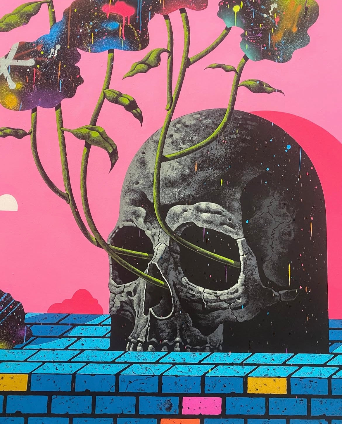 Artistic depiction of a skull with plant-like extensions against a pink background.