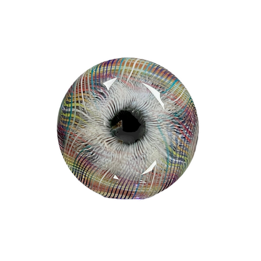 A multicolored glass marble with a mix of vibrant and muted tones, featuring a patterned design. The marble appears to have a convex surface.