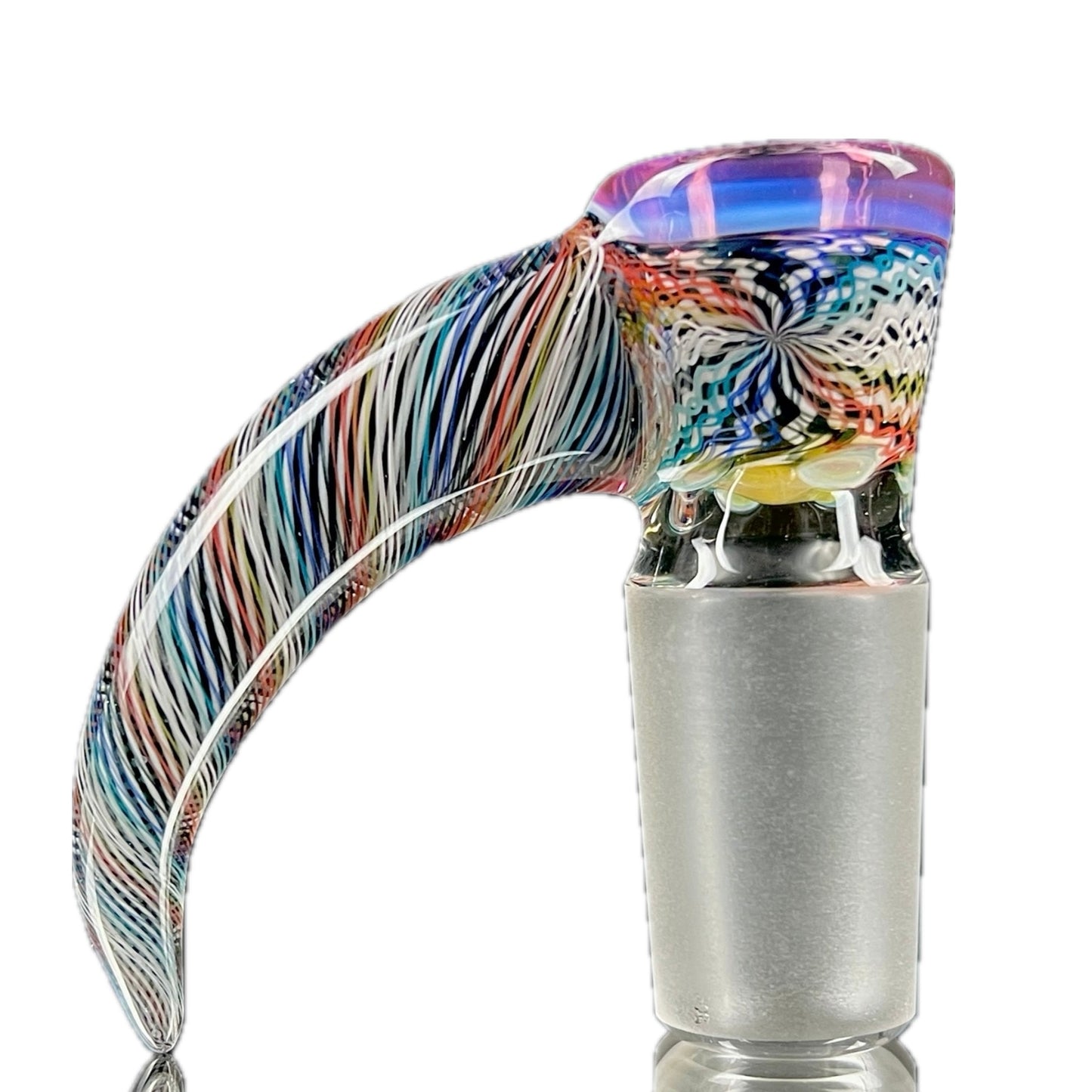 A glass piece with a multicolored, patterned body and a gold lip.
