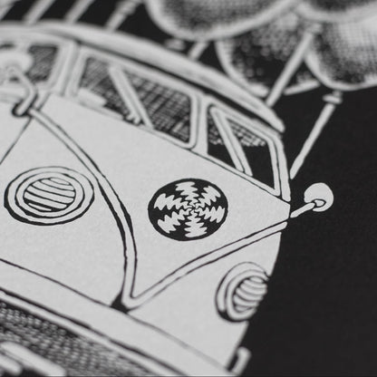 Close-up of a hand screen printed white ink on black paper, depicting a stylized bus.
