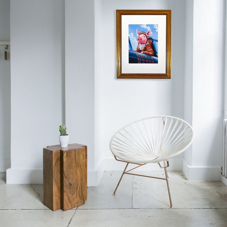 A whimsical artwork of a pig dressed as a World War 2 fighter pilot, seated in a aircraft with a blue sky background.