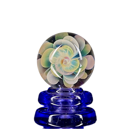 A multicolored glass marble with a flower-like pattern, approximately 30mm in diameter.