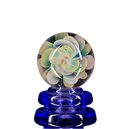 A multicolored glass marble with a flower-like pattern, approximately 30mm in diameter.