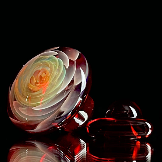 A set of three Phase Glass pieces with a swirling multicolor design, including a cap plug, valve marble, and pillar.