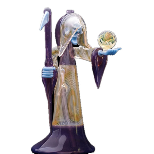 Decorative glass sculpture of a reaper holding a scythe and crystal ball.