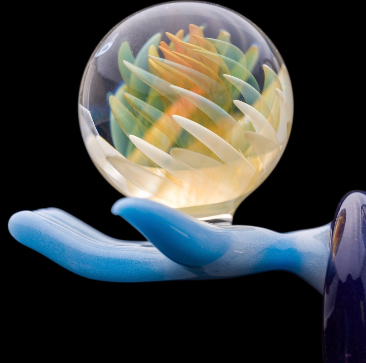 Decorative glass sculpture of a reaper holding a scythe and crystal ball.