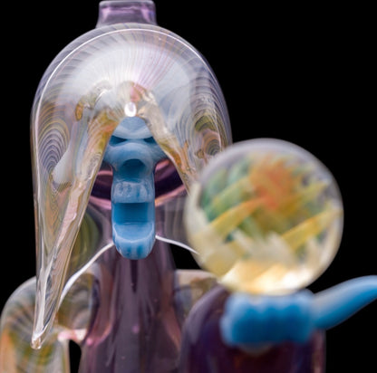 Decorative glass sculpture of a reaper holding a scythe and crystal ball.