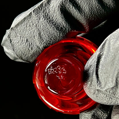 A set of three Phase Glass pieces with a swirling multicolor design, including a cap plug, valve marble, and pillar.