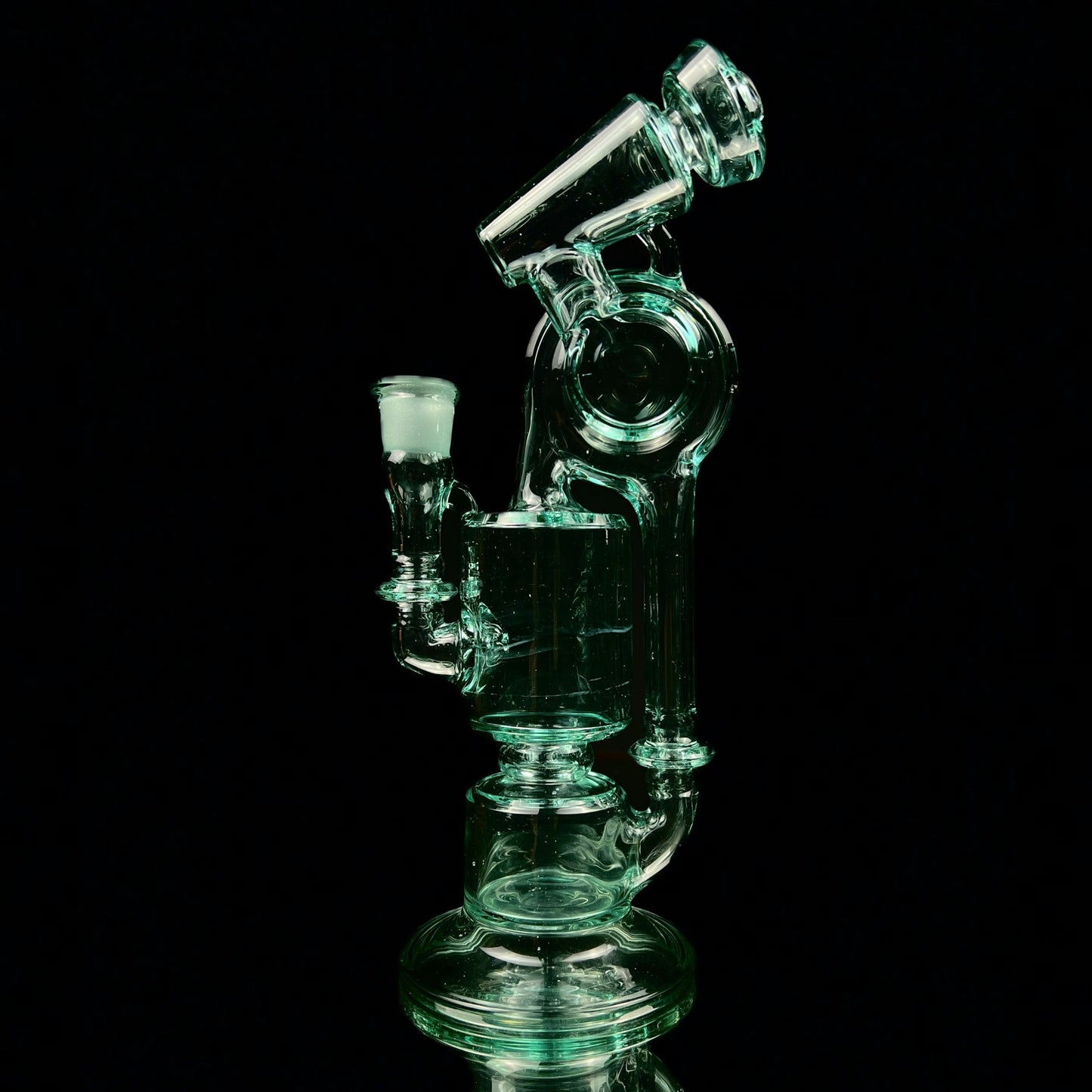 A green glass water pipe with a two-hole percolator and a small attachment at the top, standing against a black background.