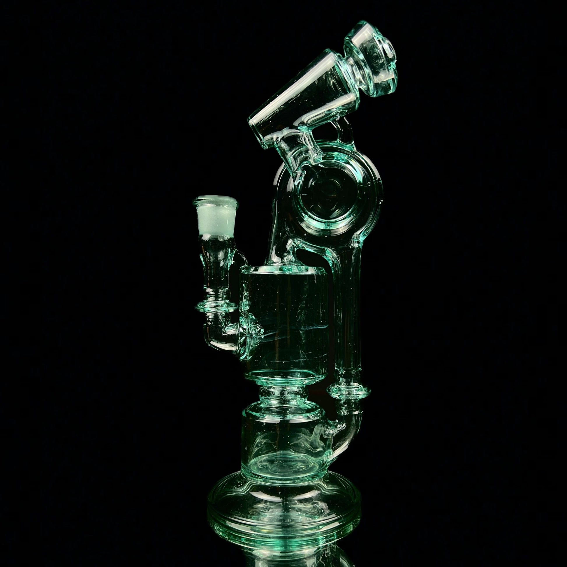 A green glass water pipe with a two-hole percolator and a small attachment at the top, standing against a black background.