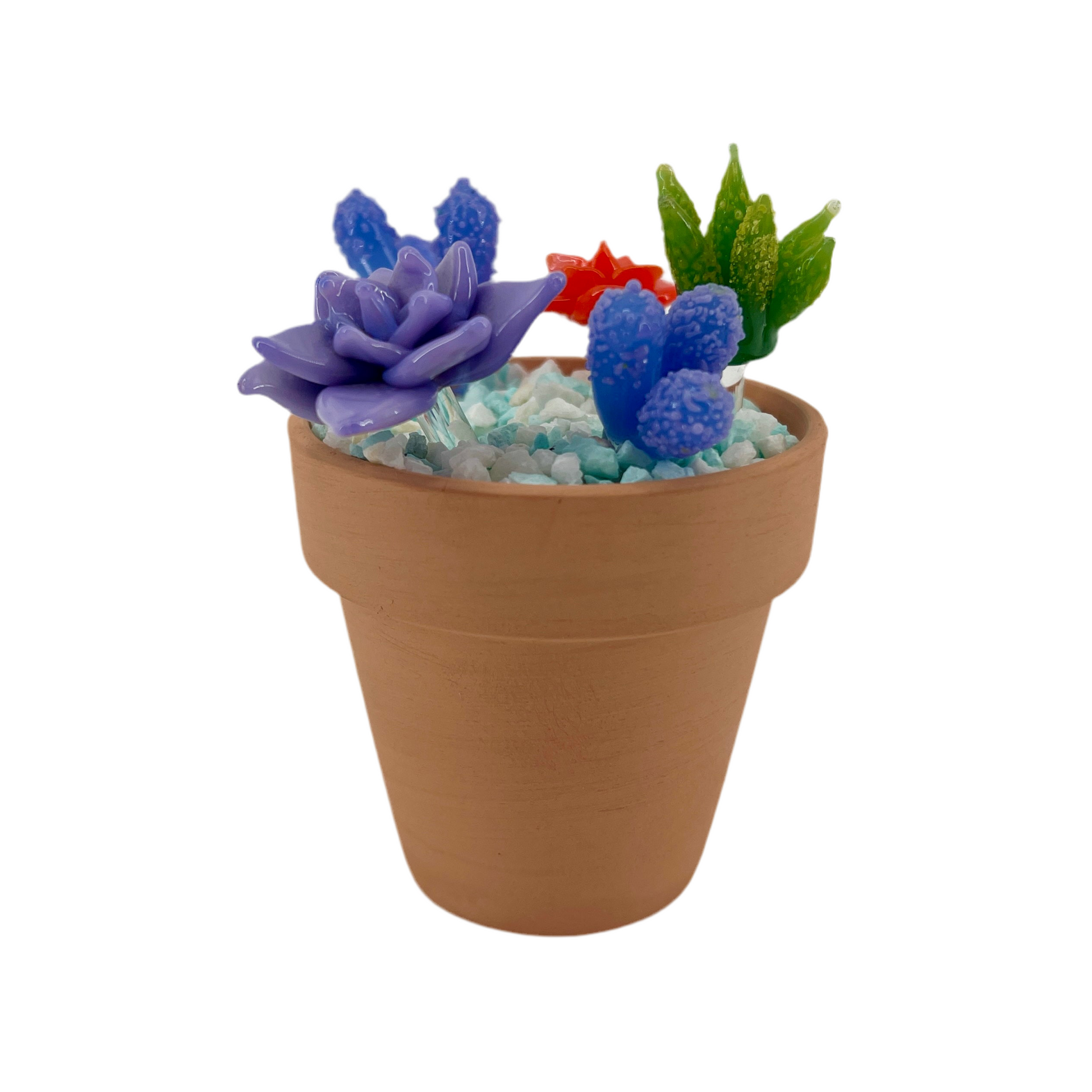 Decorative pot with artificial succulents on a white background.