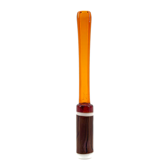 Glass sculpture with amber top and brown base on a white background