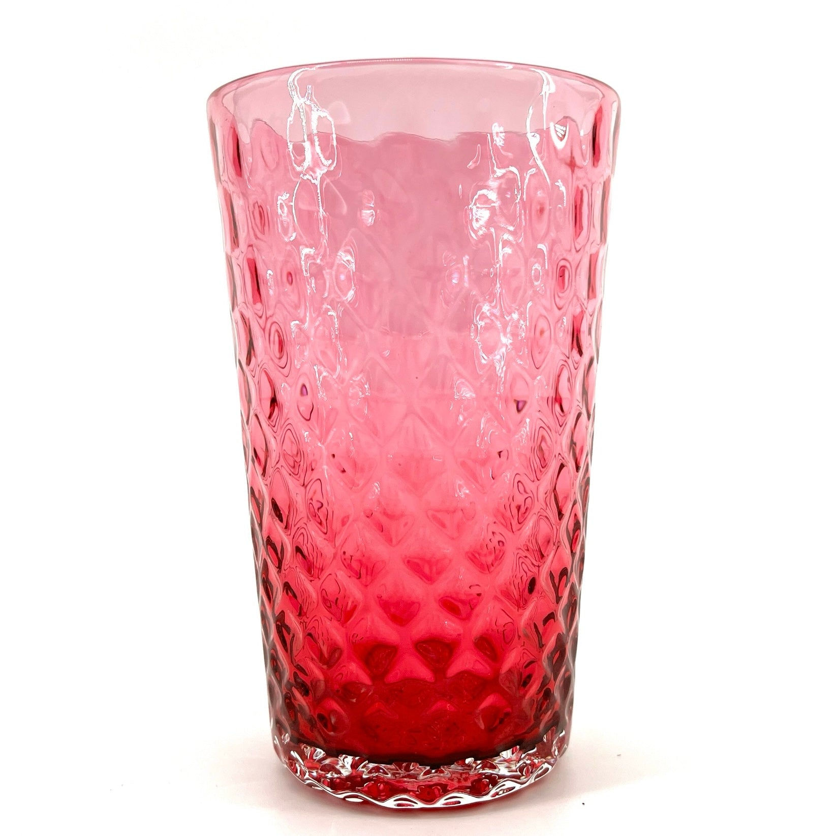 A red glass with a geometric pattern, crafted to resemble a pineapple optic design.