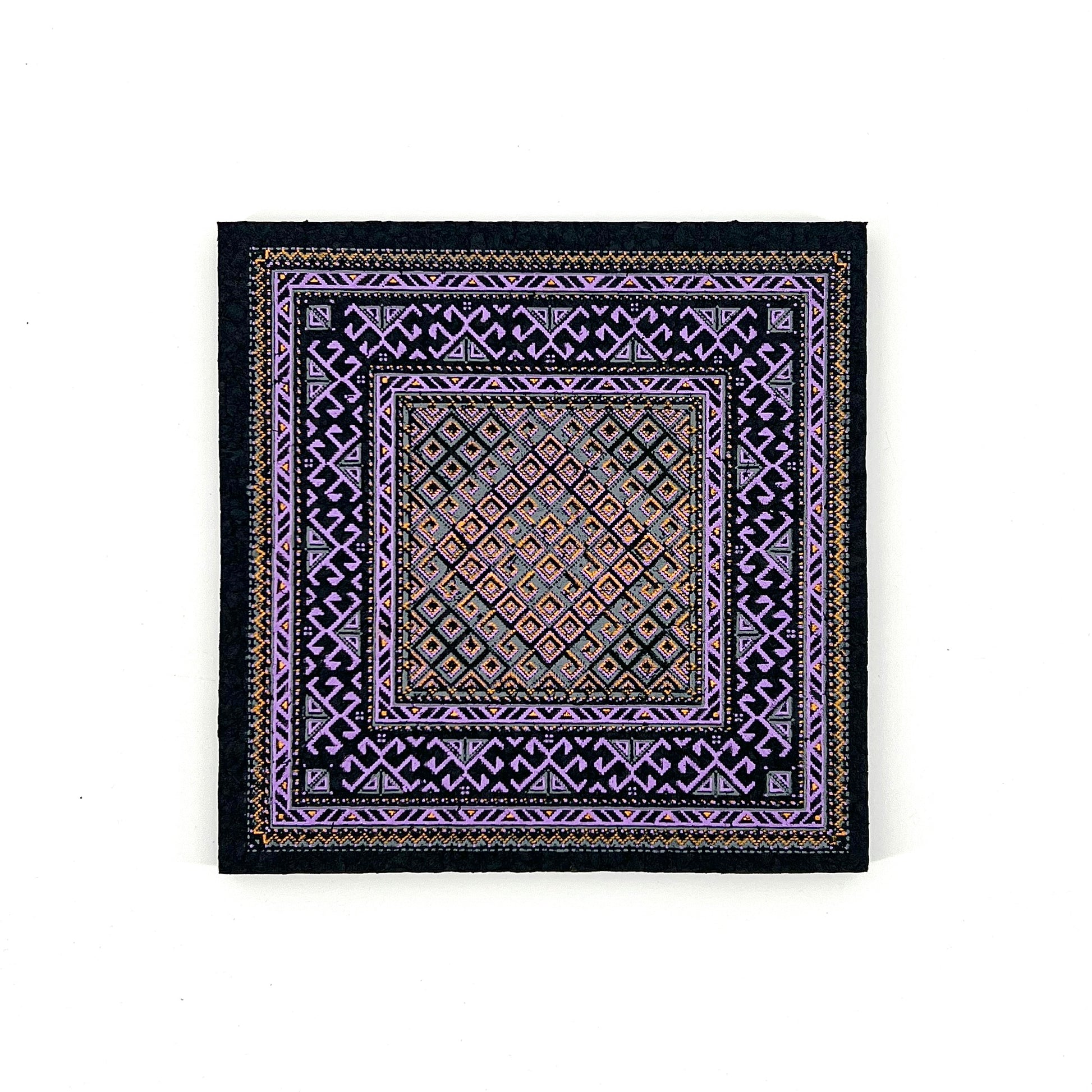 Decorative square mat with intricate patterns on a white background
