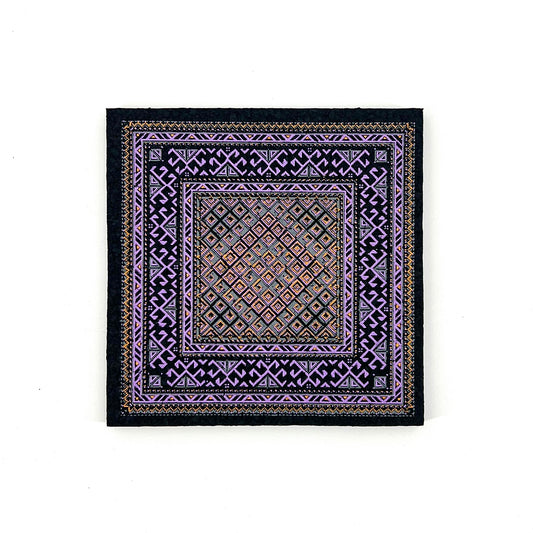 Decorative square mat with intricate patterns on a white background
