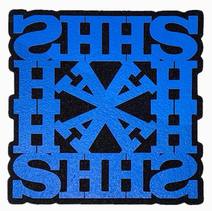 A blue and black geometric patterned rug with the text 'HASH' repeated across the design.