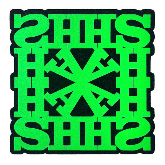 A green square-shaped rug with a geometric pattern and the text 'HASH' repeated across the design.
