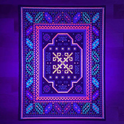 A rectangular 'High Roller Bitrug' mood mat with a geometric pattern featuring a central pink and black design, created with upcycled scraps.