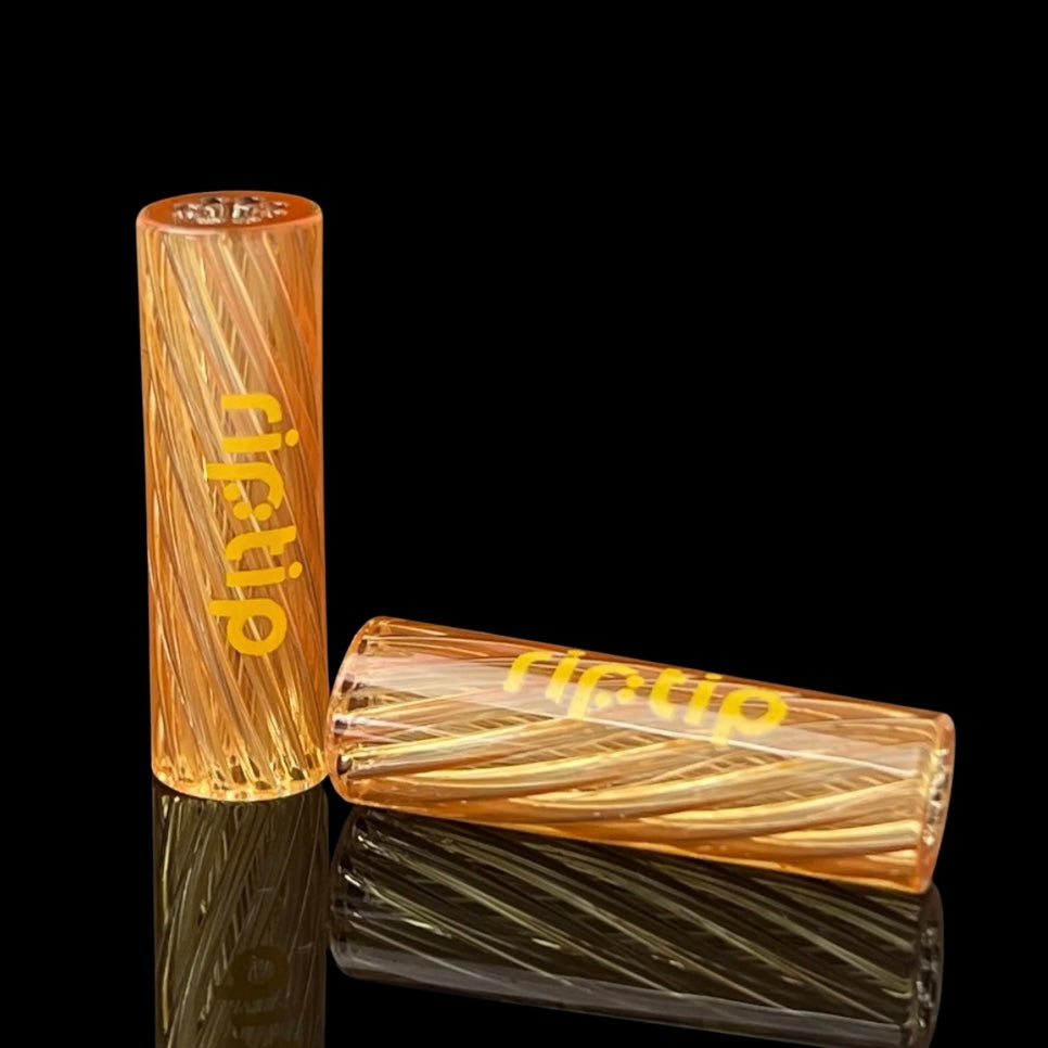 Two cylindrical glass tips with 'Gordo' branding, designed for smoking, with a yellowish tint and textured surface.