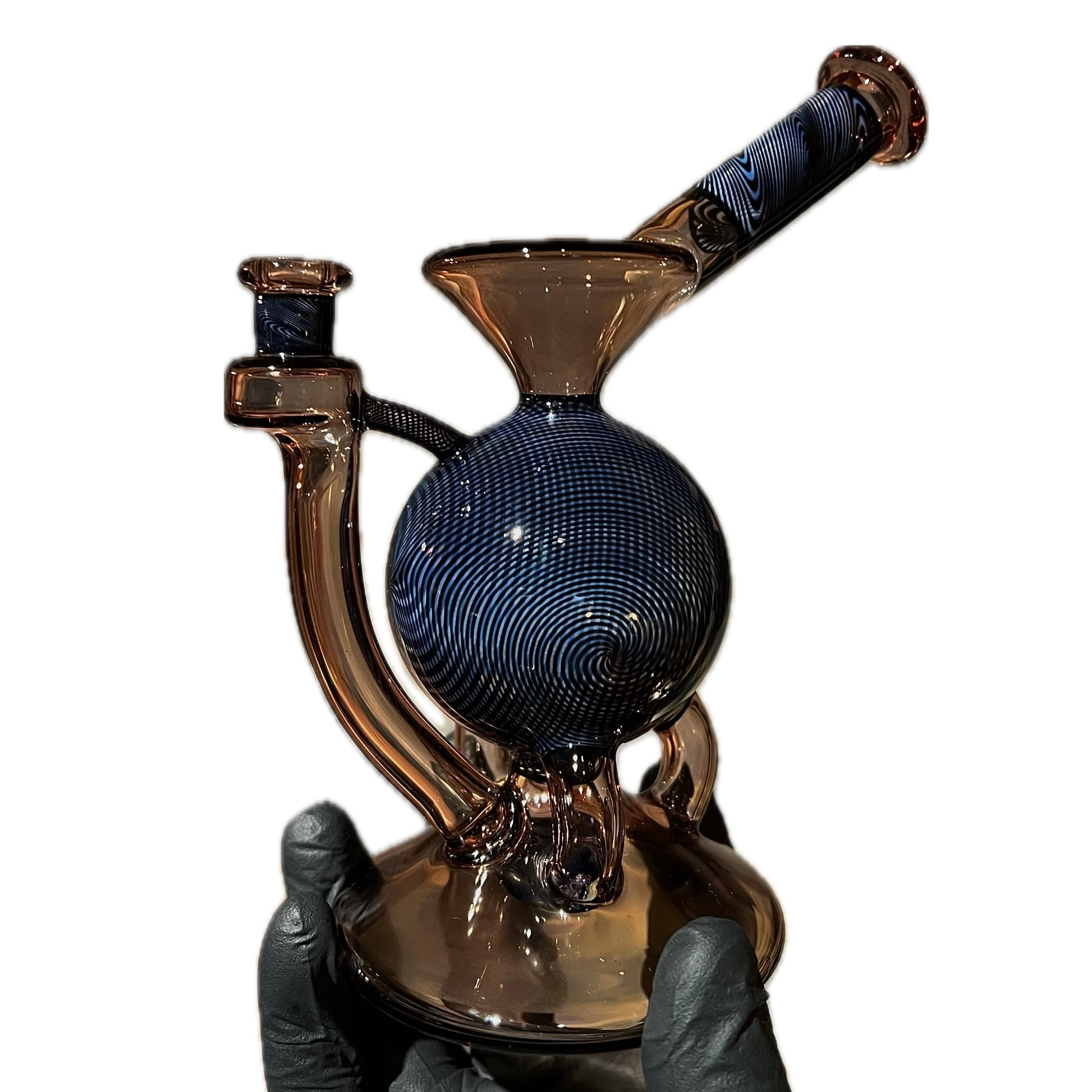 A hand holding a tall, multicolored glass piece with a 12-hole circle perc and a marble.