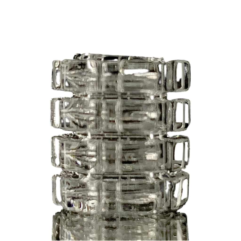 A stack of clear glass gear-shaped inserts, likely made from quartz, with visible internal threading and external ridges.