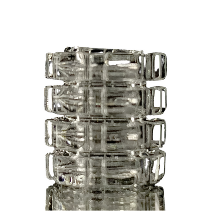 A stack of clear glass gear-shaped inserts, likely made from quartz, with visible internal threading and external ridges.