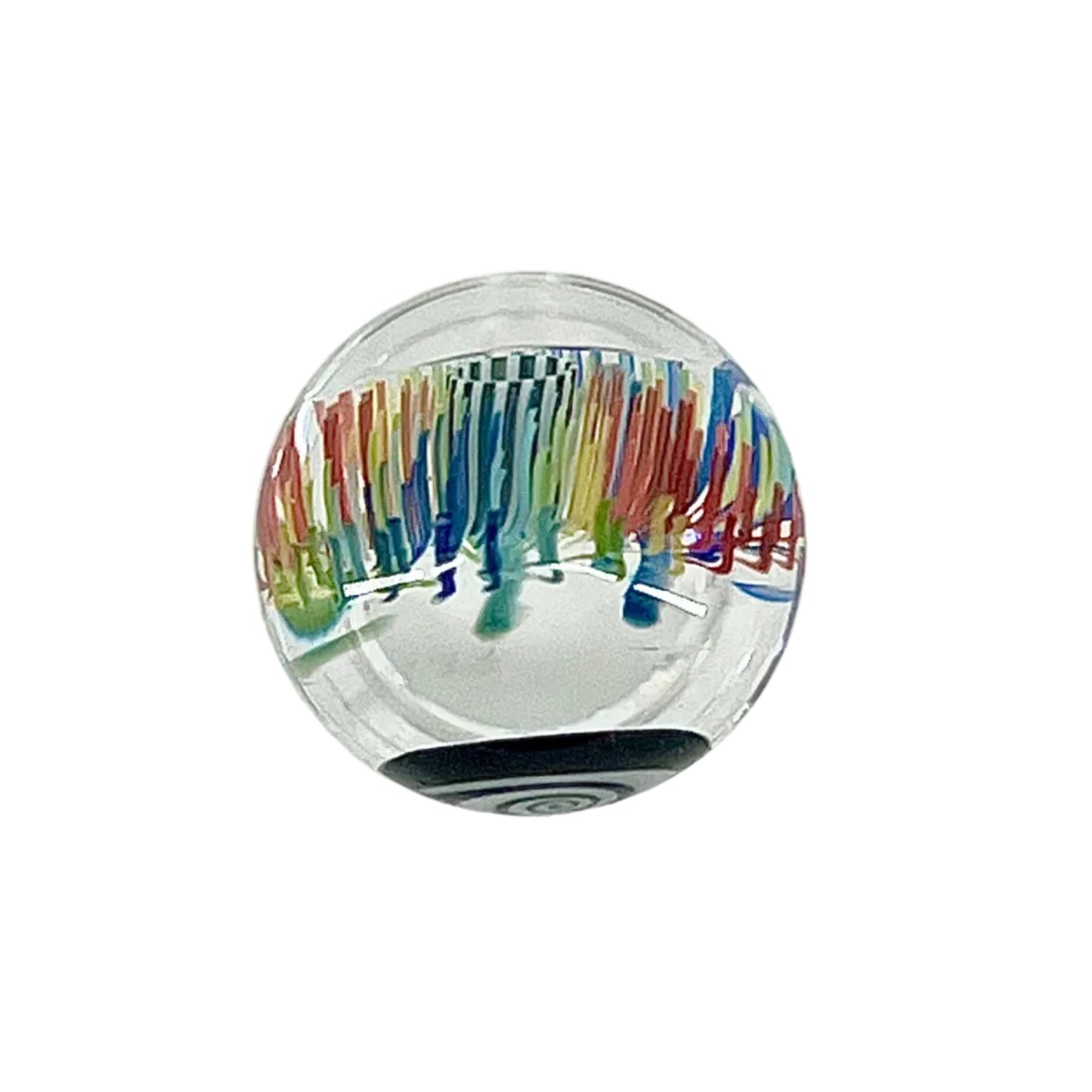 Clear glass paperweight with multicolored design on a white background.
