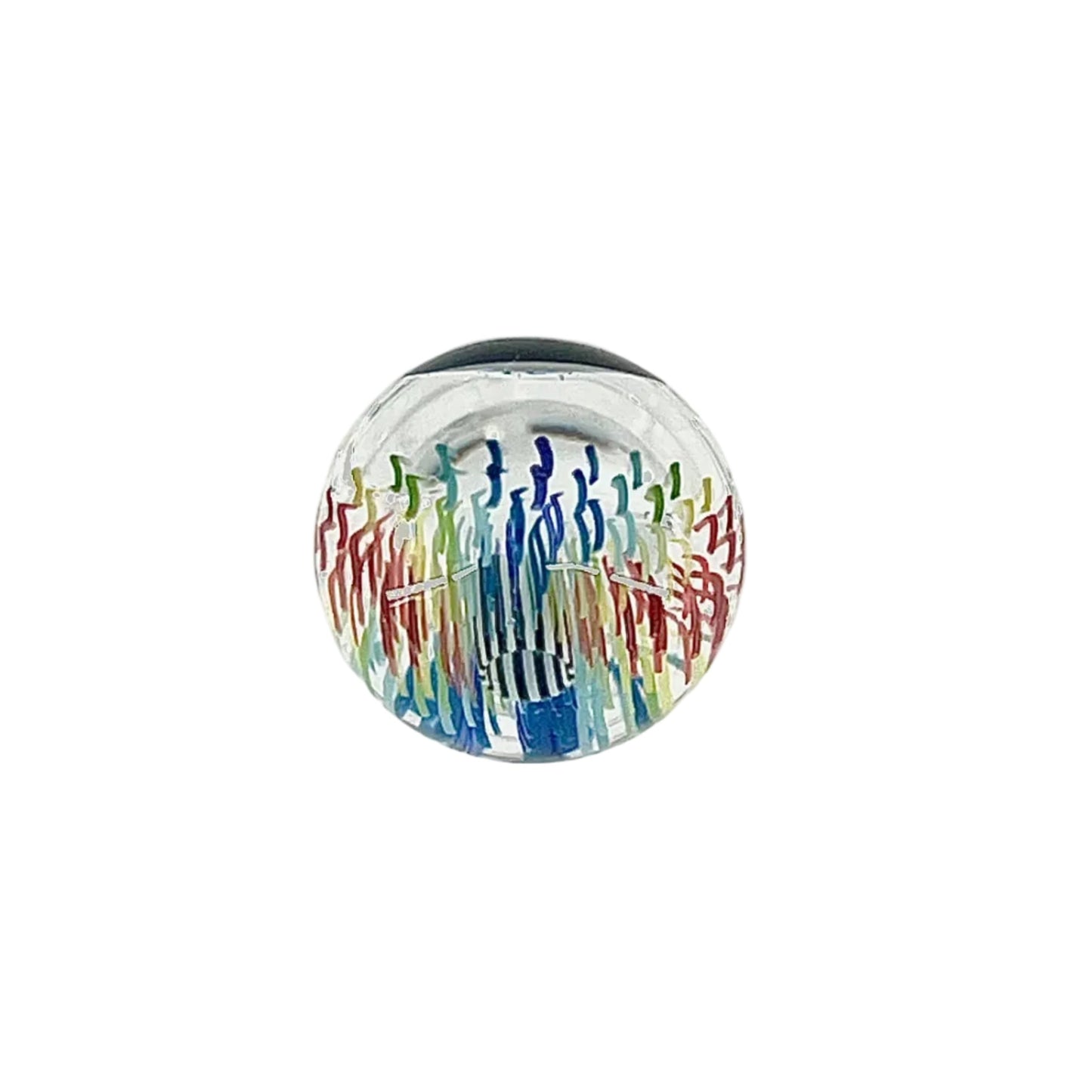 Round glass paperweight with colorful design on a white background.