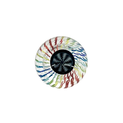 Colorful glass marble with a black center on a white background.