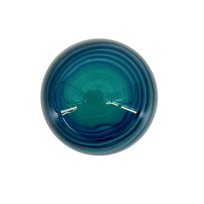 Blue glass marble on a white background.