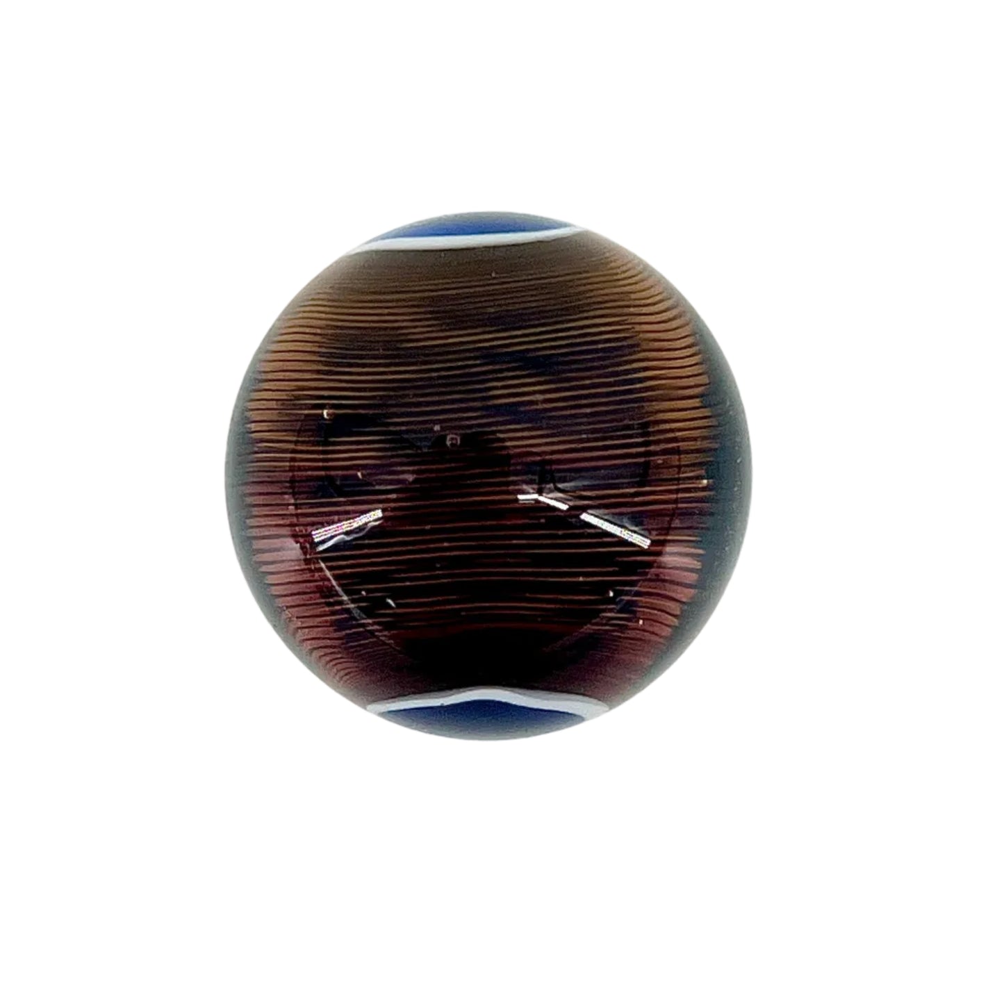 Round glass paperweight with brown and blue pattern on a white background.