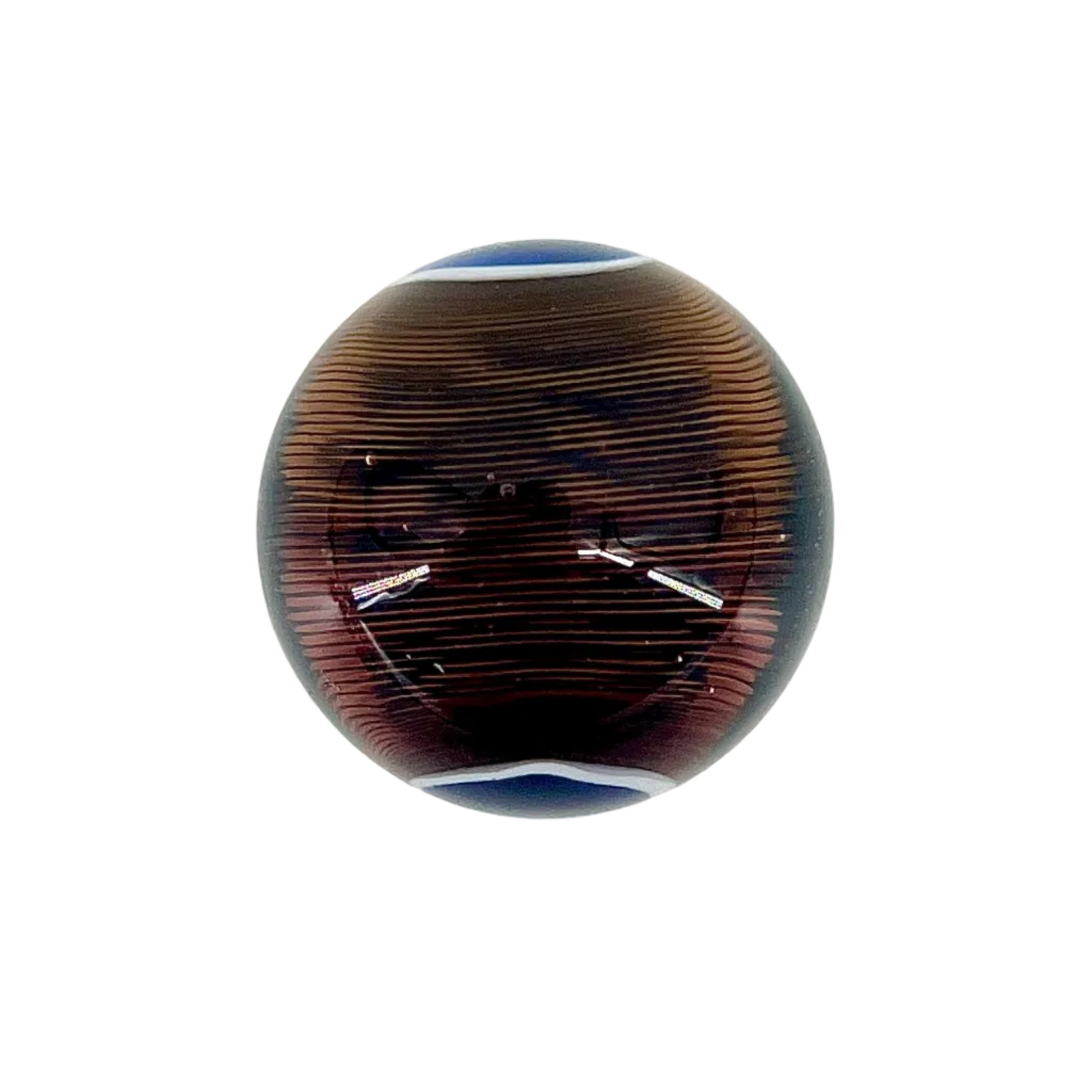 Decorative glass paperweight with brown and blue patterns on a white background.