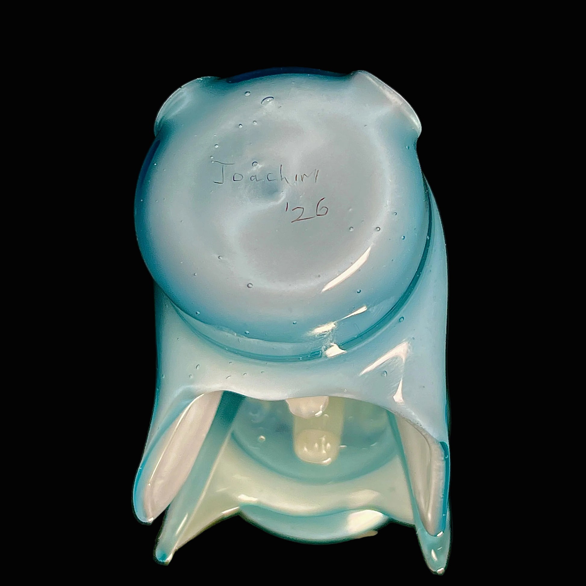 Glass hood-shaped object with 'Joachim' and '26' engraved on a black background.