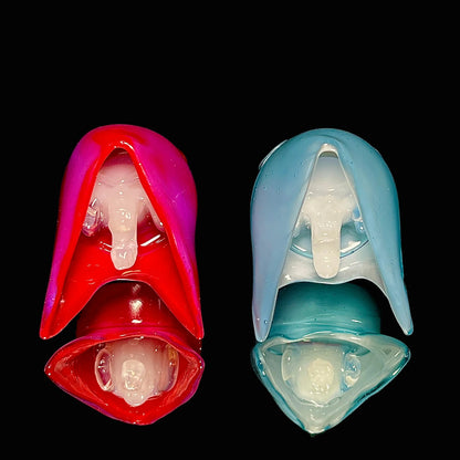 Matching reaper pendants on a black background.