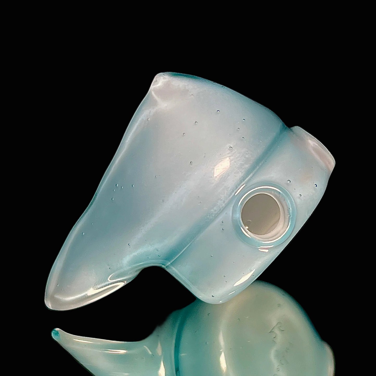 Blue glass reaper pendant on a black background.