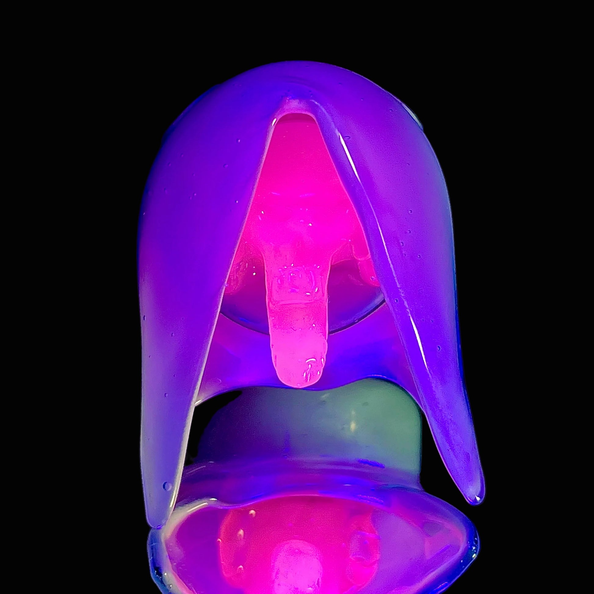 Glowing purple and pink glass pendant on a black background.