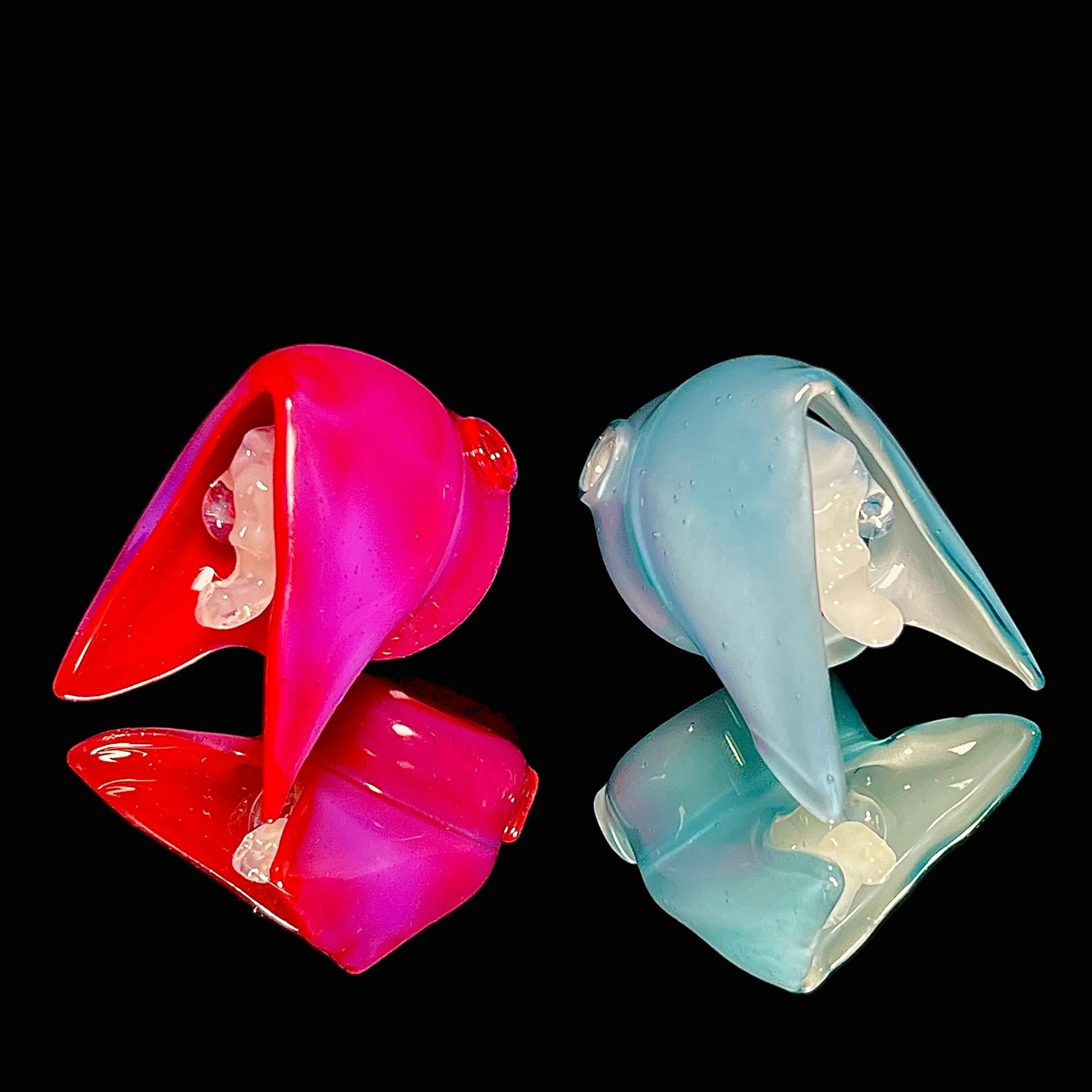 Matching reaper pendants on a black background.