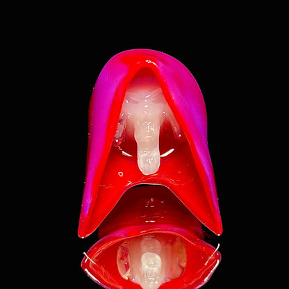 Red and pink reaper pendant on a black background.