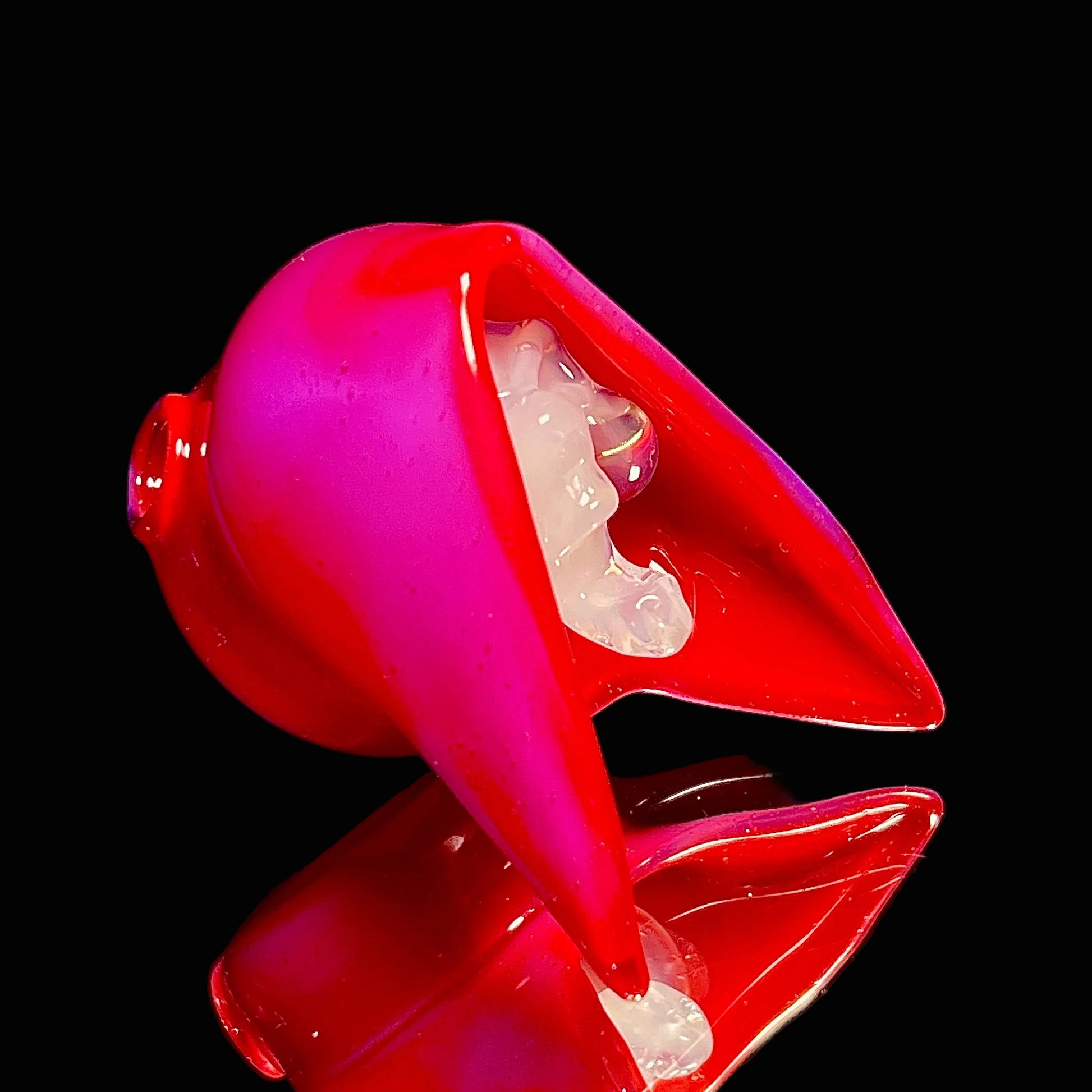 Red dental reaper pendant with a white skull on a black background.