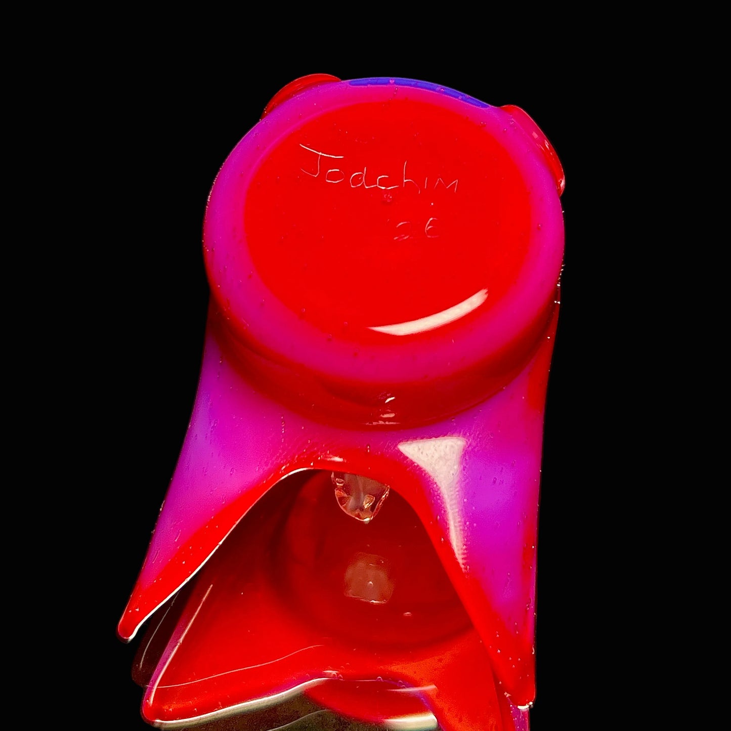 Glass pendant with signature.