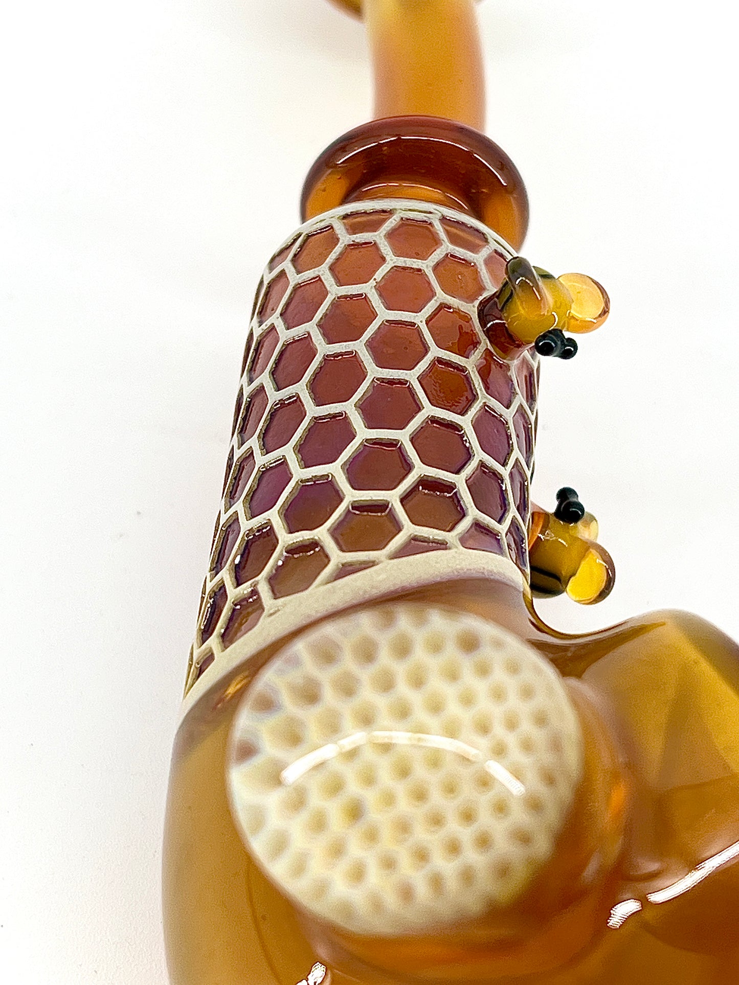 Glass pipe with honeycomb design on a white background.