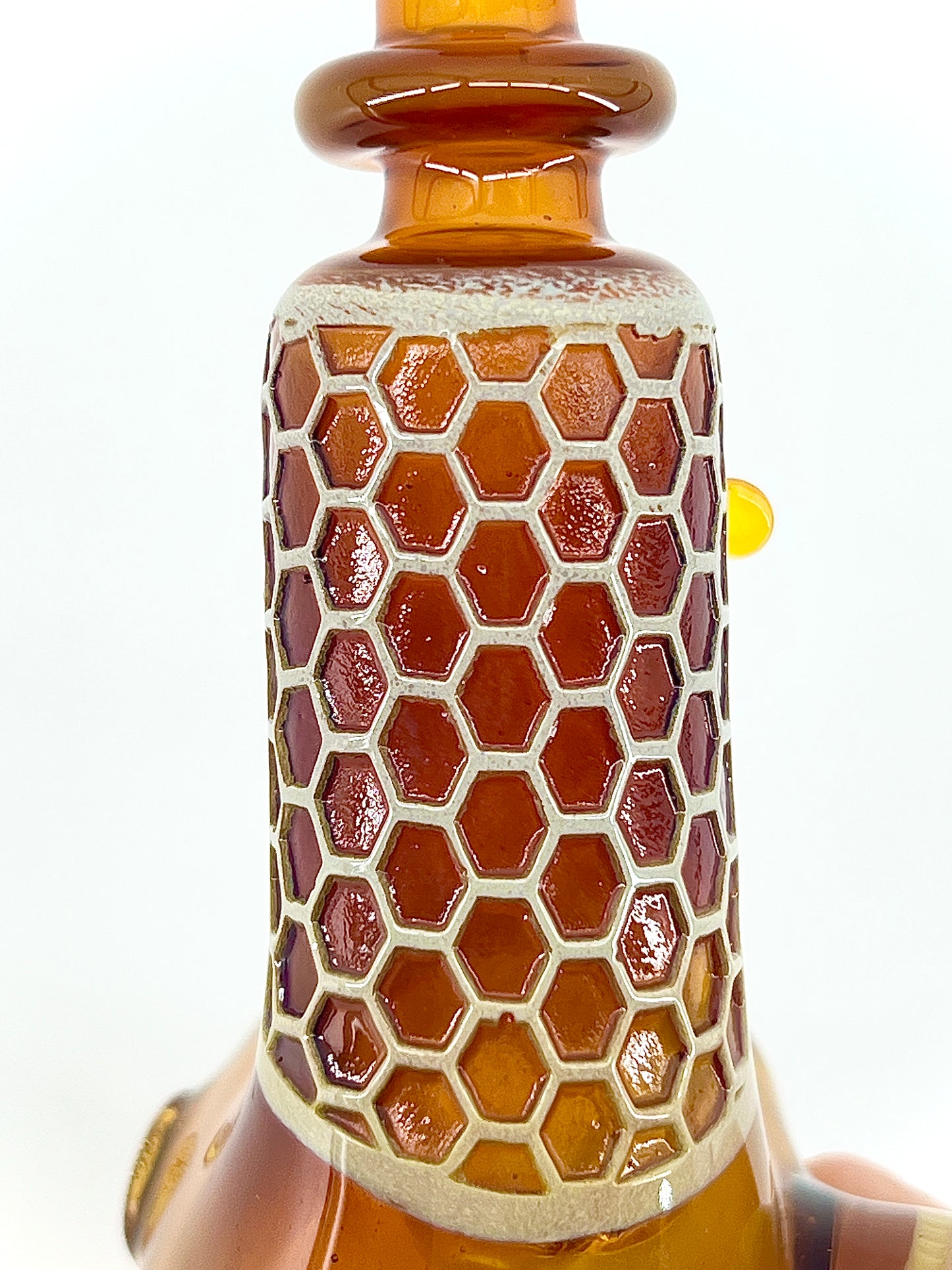 Glass with honeycomb pattern on a white background.