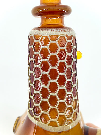 Glass with honeycomb pattern on a white background.