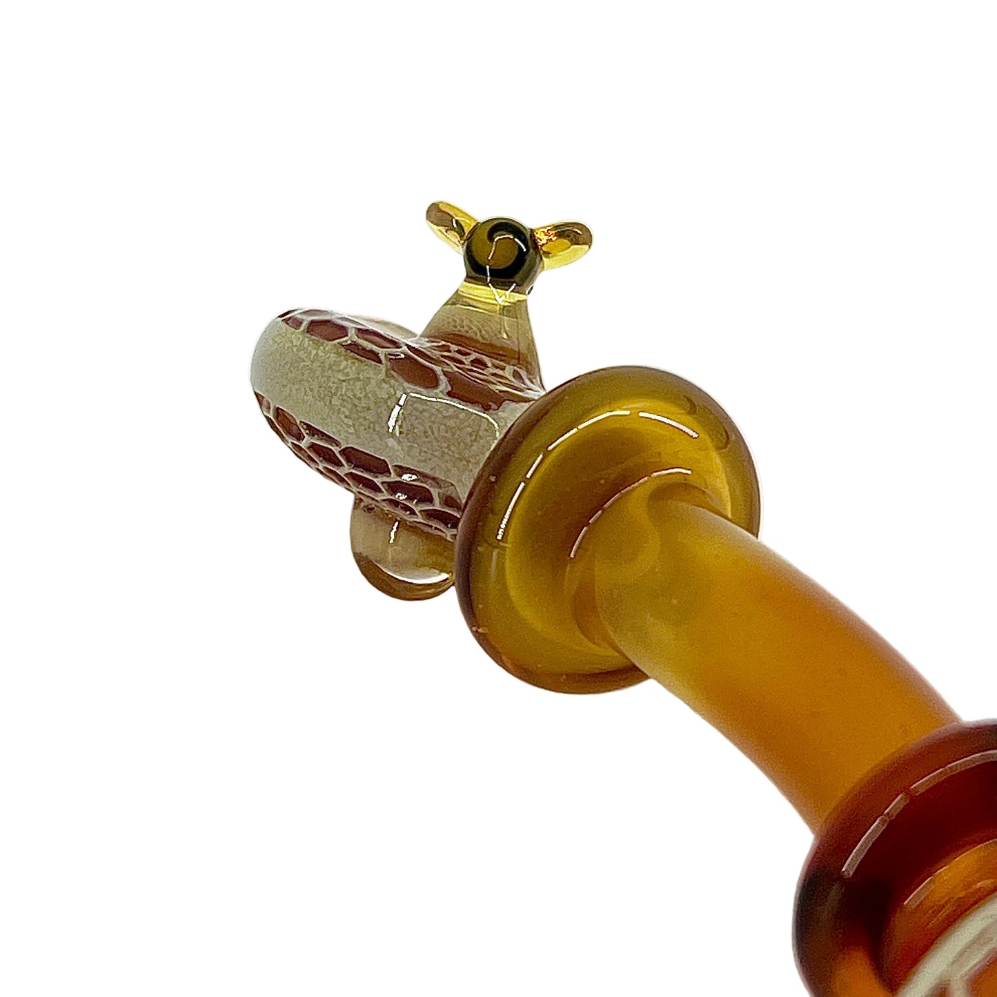 Close-up of a brown glass object with intricate design on a white background.
