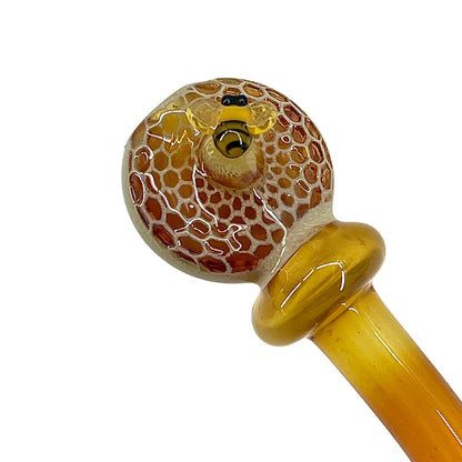 Glass pipe with honeycomb pattern on a white background.