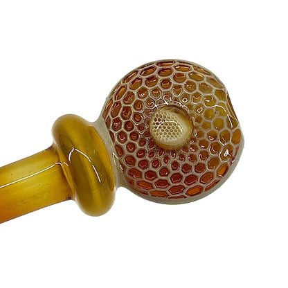 Glass pipe with honeycomb pattern on a white background.