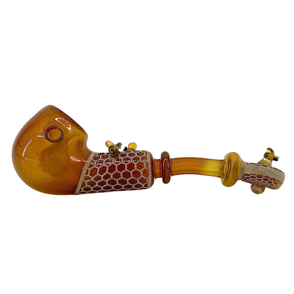 Decorative glass pipe with honeycomb pattern on a white background.