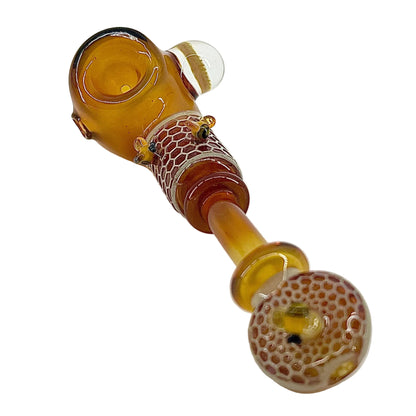 Glass pipe with brown and clear design on a white background.