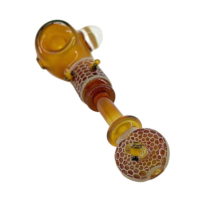 Glass pipe with honeycomb pattern on a white background.